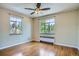 Bright bedroom featuring hardwood floors, neutral walls, ceiling fan, and dual windows at 1523 Ivy St # 6, Denver, CO 80220