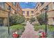 Serene courtyard with brick pathway, lush greenery, and attractive flower pots at 1523 Ivy St # 6, Denver, CO 80220