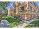 Well-maintained brick apartment building with green space and mature trees at 1523 Ivy St # 6, Denver, CO 80220