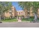 Inviting brick apartment building exterior with manicured lawn, mature trees, and gated entry at 1523 Ivy St # 6, Denver, CO 80220