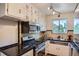Functional kitchen featuring stainless steel appliances, gas range, and ample cabinet space at 1523 Ivy St # 6, Denver, CO 80220