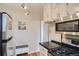 Well-equipped kitchen with stainless steel appliances, gas range, and decorative track lighting at 1523 Ivy St # 6, Denver, CO 80220