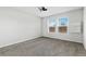 Bedroom with neutral carpet, ceiling fan, and dual windows offering great natural light at 449 Dunmire St, Frederick, CO 80530