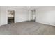 Open living room showcasing gray carpet and doorway view of the kitchen at 449 Dunmire St, Frederick, CO 80530