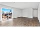 Living room with sliding glass doors leading to the deck and wood-look flooring at 449 Dunmire St, Frederick, CO 80530