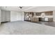 This spacious living room features carpeted floors and opens up to the kitchen and dining area at 449 Dunmire St, Frederick, CO 80530