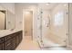 Bathroom with tiled floor, glass shower and seat, and double vanity at 483 Basin Daisy St, Castle Rock, CO 80104