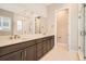 Bathroom with double vanity, marble countertops, dark cabinets, and tiled floors at 483 Basin Daisy St, Castle Rock, CO 80104