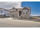 Charming two-story home with stone accents, an attached garage, and professional landscaping at 483 Basin Daisy St, Castle Rock, CO 80104