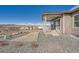 Side view of a home with a covered porch and gravel landscaping, creating a comfortable space at 483 Basin Daisy St, Castle Rock, CO 80104