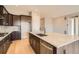 Beautiful gourmet kitchen with dark cabinets, marble counters, and stainless appliances at 483 Basin Daisy St, Castle Rock, CO 80104