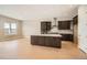 New kitchen with stainless appliances, center island, herringbone backsplash and hardwood floors at 483 Basin Daisy St, Castle Rock, CO 80104
