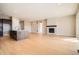 Open living area with a modern fireplace, kitchen island, and sliding glass doors at 483 Basin Daisy St, Castle Rock, CO 80104