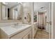 A bright bathroom featuring a quartz countertop vanity with modern hardware and a shower at 25694 Stansbery St, Conifer, CO 80433