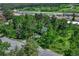 Aerial view showcases the neighborhood, nestled amidst lush trees and a nearby shopping area at 25694 Stansbery St, Conifer, CO 80433