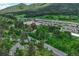 Aerial view showcases proximity to shopping area nestled amongst trees and natural surroundings at 25694 Stansbery St, Conifer, CO 80433