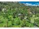 Aerial view of a gray home surrounded by dense forest and natural beauty at 25694 Stansbery St, Conifer, CO 80433
