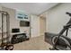 Finished basement with neutral carpet, a window, TV, exercise equipment and an open doorway at 25694 Stansbery St, Conifer, CO 80433