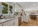 The kitchen features granite counters, stainless appliances, and backyard views from the window over the sink at 25694 Stansbery St, Conifer, CO 80433