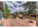 Outdoor deck with seating, grill, and beautiful views of the surrounding nature at 25694 Stansbery St, Conifer, CO 80433