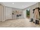 A charming kitchenette with gray cabinets, microwave, small fridge, and sliding door to the outside deck at 25694 Stansbery St, Conifer, CO 80433