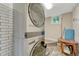 Modern laundry room featuring a stacked washer/dryer, white subway tile, and a bright window at 25694 Stansbery St, Conifer, CO 80433