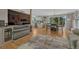 Bright living room with hardwood floors, modern fireplace, and dining area at 25694 Stansbery St, Conifer, CO 80433