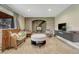 Cozy living room with brick fireplace, hearth and rustic wood stove and plush carpeting at 25694 Stansbery St, Conifer, CO 80433
