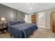 Spacious bedroom features wood accent wall, ample natural light, and ensuite bathroom access at 25694 Stansbery St, Conifer, CO 80433