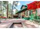 Spacious backyard patio with outdoor seating, fire pit, and a green wooden deck at 5030 Cedar Way, Elizabeth, CO 80107