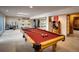 Spacious carpeted basement features a pool table, gym area, and mirrored wall for workouts at 5030 Cedar Way, Elizabeth, CO 80107