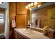 Cozy bathroom with wooden walls, tile counter and a relaxing ambiance at 5030 Cedar Way, Elizabeth, CO 80107