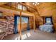 Bedroom features wooden walls, a fireplace, loft, ladder, carpeted floor, and a plush bed at 5030 Cedar Way, Elizabeth, CO 80107