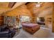 Wood paneled bedroom features a plush carpet, large bed, and built in shelving to display decor at 5030 Cedar Way, Elizabeth, CO 80107