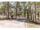 Gated driveway entrance flanked by wood posts and lush landscaping, offering privacy and charm at 5030 Cedar Way, Elizabeth, CO 80107