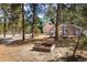 Exterior view of home with a green roof, wood siding, and a fire pit in the yard at 5030 Cedar Way, Elizabeth, CO 80107