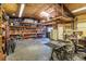 Spacious garage with work tables, shelving and lots of storage space with a high ceiling for a car lift at 5030 Cedar Way, Elizabeth, CO 80107
