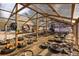 Interior of a greenhouse with wooden framing and various plants growing in containers at 5030 Cedar Way, Elizabeth, CO 80107