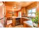 Eat-in kitchen featuring wood-paneled walls and a view to the dining room at 5030 Cedar Way, Elizabeth, CO 80107