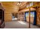Spacious living room with wooden walls, fireplace, and a loft area with a ladder for access at 5030 Cedar Way, Elizabeth, CO 80107