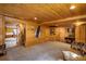 Large finished basement features light wood paneling, carpet, and access to the pool room at 5030 Cedar Way, Elizabeth, CO 80107