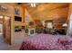 Unique main bedroom boasts a stone fireplace and built-in shelving in the vaulted ceiling at 5030 Cedar Way, Elizabeth, CO 80107