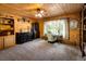 Sunlit office area featuring warm wood paneling, desk, and a tranquil backyard view at 5030 Cedar Way, Elizabeth, CO 80107