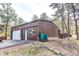 Spacious outbuilding features an automatic door, side entry, and room for wood storage on the side at 5030 Cedar Way, Elizabeth, CO 80107