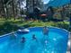 In-ground pool perfect for swimming and enjoying the outdoors on a sunny day, with house in the background at 5030 Cedar Way, Elizabeth, CO 80107