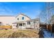 Spacious backyard with covered deck and winter lawn at 5285 S Jericho Way, Centennial, CO 80015