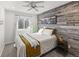 Stylish bedroom highlighting a distinctive wood-paneled wall, a queen-size bed, and soft natural light at 5285 S Jericho Way, Centennial, CO 80015