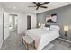 Comfortable bedroom with a cozy white bed, a walk-in closet, and en-suite access at 5285 S Jericho Way, Centennial, CO 80015