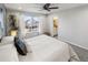 Airy bedroom showcasing a well-lit interior, a large window, and glimpses of the en-suite bathroom at 5285 S Jericho Way, Centennial, CO 80015