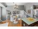 Bright, open-concept kitchen and dining area with modern lighting and a view into the living space at 5285 S Jericho Way, Centennial, CO 80015